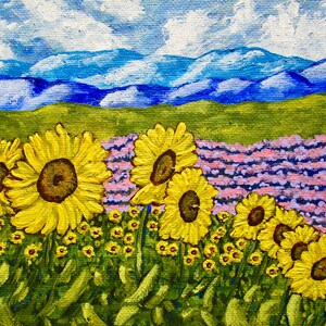 May include: An acrylic painting on canvas depicting a field of bright yellow sunflowers in the foreground, a patch of purple lavender in the midground, and rolling blue mountains under a sky with white clouds in the background.