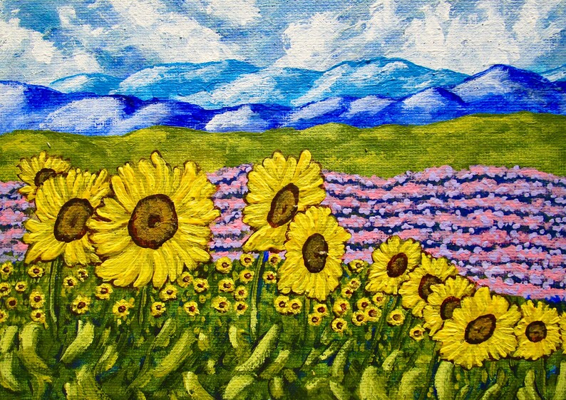 May include: An acrylic painting on canvas depicting a field of bright yellow sunflowers in the foreground, a patch of purple lavender in the midground, and rolling blue mountains under a sky with white clouds in the background.