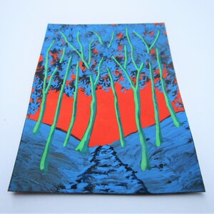 May include: A painting depicting a forest scene with green trees against a bright orange sky. The trees are painted in a stylised way, with thick, dark blue trunks and green branches. The sky is a vibrant orange, with a hint of pink at the edges. The painting is done on a textured surface, giving it a rough, almost abstract look.