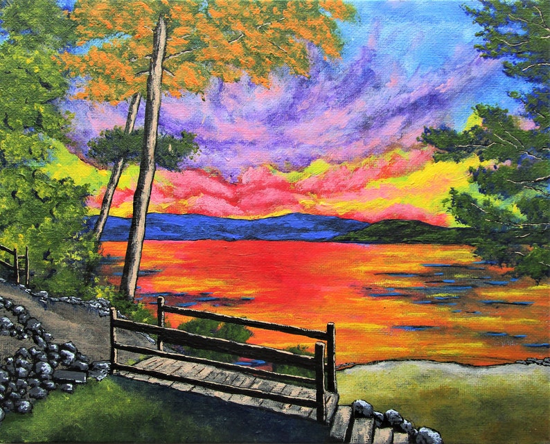May include: An acrylic painting of a vibrant sunset over a lake, featuring a wooden footbridge in the foreground, rocky terrain, and lush green trees. The sky is filled with intense shades of purple, pink, and yellow, reflecting on the water.