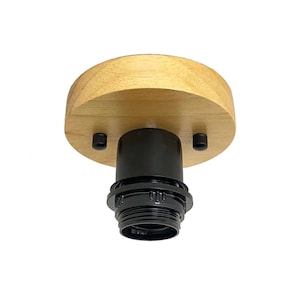 May include: A ceiling light fixture with a natural wood finish and a black socket. The round wooden base has a light brown color and is attached to the black socket with two screws. The fixture is designed for easy installation.