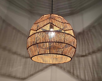 May include: A woven, round, light fixture with a natural brown color. The light fixture is made of rope and has a geometric pattern.