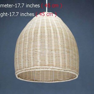 May include: A natural woven pendant light fixture made of light brown wicker. The light is 17.7 inches in diameter and 17.7 inches tall.