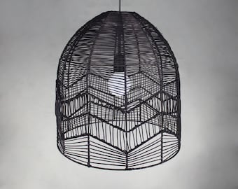 May include: Black woven pendant light fixture with a geometric pattern. The light fixture is made of natural materials and has a rustic, bohemian style.
