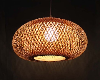 May include: A round, woven bamboo pendant light fixture with a warm, glowing light emanating from the center.