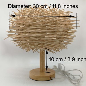 table lamp,bedside table lamp,desk lamp,housewarming table lamp,nightstand lamp,Handmade table lamp
Rattan woven light
Bohemian decor
Natural rattan lamp
Wooden base lamp
Eco-friendly lighting
Rustic table light
Unique home decor
Customizable lamp
Handcrafted fixture
Modern boho lamp
Gift for home
Sustainable decor
