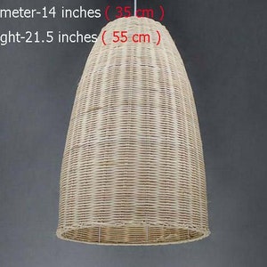 May include: A woven wicker pendant light shade in a natural beige color. The shade is 14 inches in diameter and 21.5 inches tall.