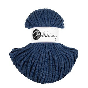 May include: A spool of dark blue cotton rope, labeled "Bobbiny".
