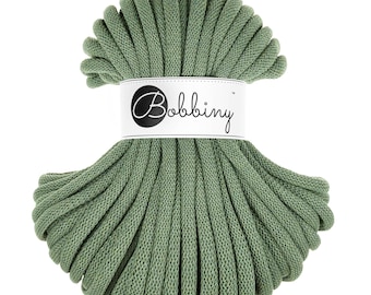 May include: A spool of green cotton rope, labeled "Bobbiny" in a white circle with black text.