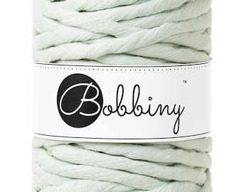 May include: A skein of light green cotton yarn with the brand name "Bobbiny" printed on a white label.