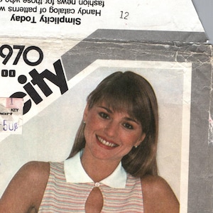 May include: A sewing pattern for a sleeveless top with a keyhole neckline. The pattern is for sizes 12, 14, and 16. The pattern is from Simplicity and is called "One-Yard Tops".