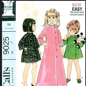 May include: Vintage McCall's pattern for child's robes in two lengths. The illustration shows three children wearing robes in pink, green, and black with white polka dots. The pattern includes a two-color guide and is size 2.