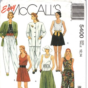 May include: A set of three ceramic vases in varying heights and shapes. The vases are glazed in a matte white finish, offering a minimalist aesthetic. The tallest vase is approximately 10 inches high.