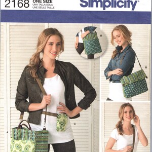 May include: Simplicity pattern 2168, featuring a tote bag, crossbody bag, and belt bag. The bags have a green and blue paisley design. The pattern includes the text "ONE SIZE".