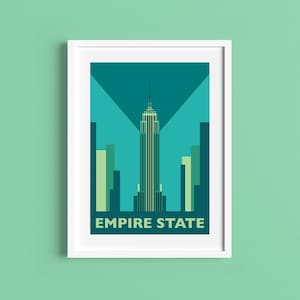 May include: A framed art print featuring a stylized illustration of the Empire State Building in New York City. The artwork uses shades of teal, green, and blue. The words "EMPIRE STATE" are printed at the bottom.