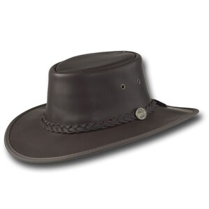 May include: A brown leather cowboy hat with a braided band and a metal logo that says "Akubra" on it.