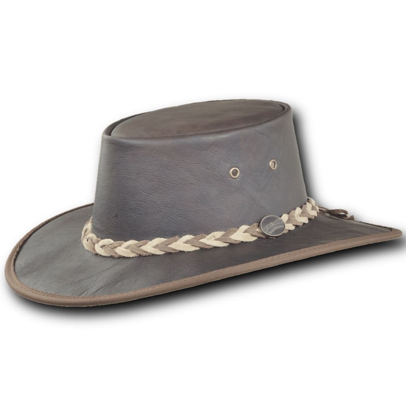 May include: A brown leather cowboy hat with a braided leather band. The hat has a wide brim and a tall crown.