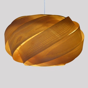 May include: A wooden pendant light fixture with a unique, swirling design. The light is made of multiple layers of wood that are woven together to create a unique and modern look.