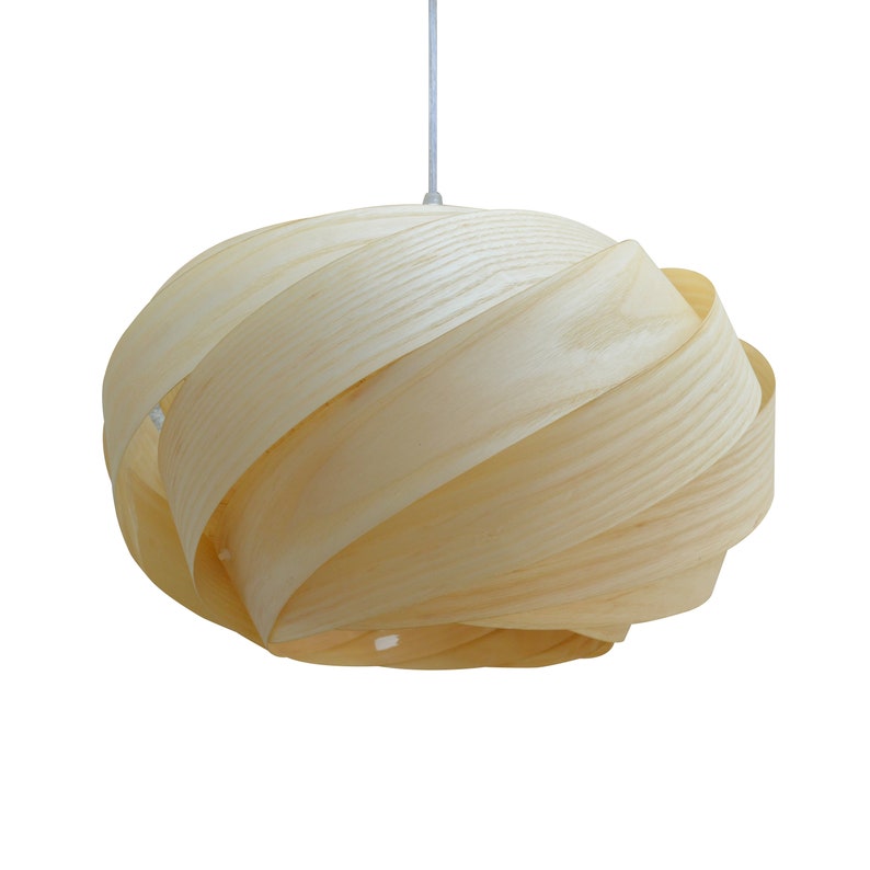 May include: A light wood pendant lamp with a unique, swirling design. The lampshade is made of thin, layered wood strips that create a natural and organic look.