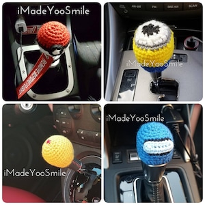 May include: Four crochet shift knobs in a car. One is red and white, another is yellow, blue, and white, a third is yellow with a red star, and the last is blue and white. The text "iMade YooSmile" appears in each image.