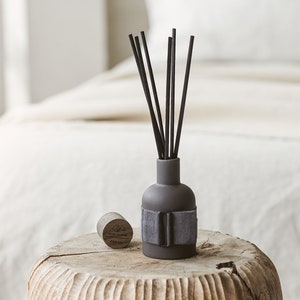 BLACK REED DIFFUSER: glamour, eenheid, fortuin, droom. Keramische vaas met eiken deksel, zwarte rietstengels en navulfles van 100 ml in zwarte geschenkdoos