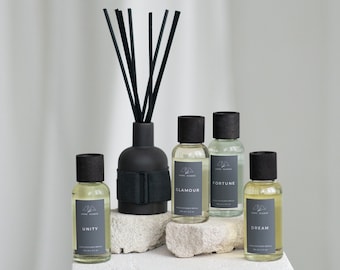 DIFUSOR DE VARILLAS NEGRAS: Glamour, Unidad, Fortuna, Sueño. Jarrón de cerámica con tapa de roble, varillas negras y botella de recarga de 100 ml en caja de regalo negra.
