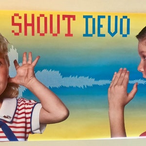 May include: A yellow and blue poster with the text "SHOUT DEVO" in red and blue letters. A young girl with blonde hair is covering her ear with her hand. A young boy with brown hair is cupping his hand to his ear and looking to the right. The poster has a blue and white sound wave graphic.