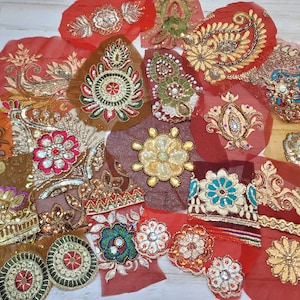 May include: Assortment of colorful embroidered fabric patches with sequins and beads. The patches feature floral, paisley, and geometric designs.