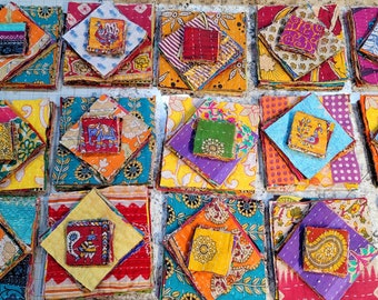 May include: A collection of colourful fabric squares, each layered and stitched together to create a unique patchwork design. The squares are arranged in rows and columns, showcasing a variety of patterns and textures.