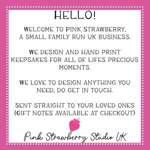 May include: A white square sign with a pink border featuring white dots. The text reads: HELLO! WELCOME TO PINK STRAWBERRY, A SMALL FAMILY RUN UK BUSINESS. WE DESIGN AND HAND PRINT KEEPSAKES FOR ALL OF LIFES PRECIOUS MOMENTS. WE LOVE TO DESIGN ANYTHING YOU NEED, DO GET IN TOUCH. SENT STRAIGHT TO YOUR LOVED ONES (GIFT NOTES AVAILABLE AT CHECKOUT). A small pink strawberry icon is centered above the text Pink Strawberry Studio UK.