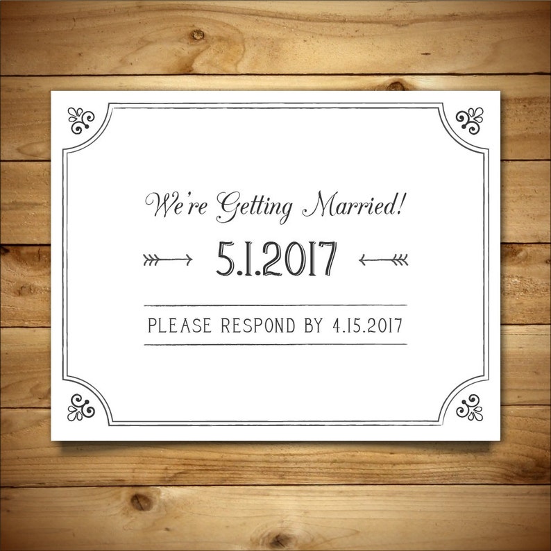 May include: A white wedding announcement card with a black border and ornate corners. The text reads "We're Getting Married! 5.1.2017 Please Respond by 4.15.2017"
