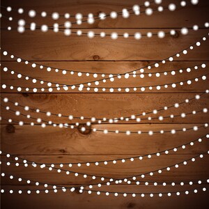 May include: A rustic wooden background with multiple strands of white string lights hanging across it. The lights are evenly spaced and create a warm, inviting atmosphere.