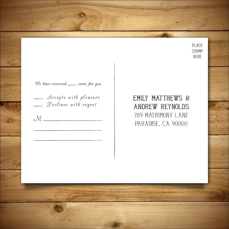 May include: A white RSVP postcard with black text. The text reads "We have reserved seats for you. Accepts with pleasure. Declines with regret."  The postcard also includes the names "Emily Matthews & Andrew Reynolds" and their address "789 Matrimony Lane, Paradise, CA 90000".