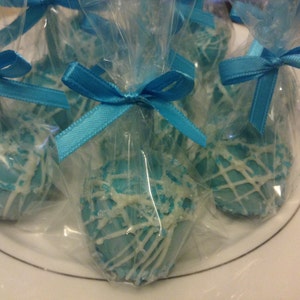 May include: Blue and white cake pops wrapped in clear cellophane bags with blue ribbon bows.