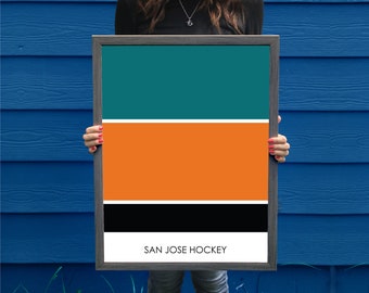 May include: A framed print of the San Jose Sharks hockey team's color scheme. The print features three horizontal stripes in teal, orange, and black. The text "SAN JOSE HOCKEY" is printed in white at the bottom of the print.