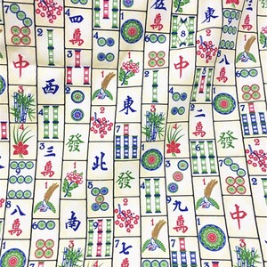 May include: A colourful fabric with a repeating pattern of Chinese mahjong tiles. The tiles feature various Chinese characters and numbers, along with bamboo, flowers, and circles. The fabric is a light beige colour with green, red, blue, and black accents.