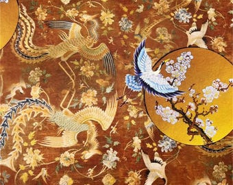 May include: A detailed textile featuring a repeating pattern of golden phoenixes, cranes, and floral elements on a rich, reddish-brown background. The design includes circular gold accents with cherry blossom branches, creating an ornate and elegant aesthetic.