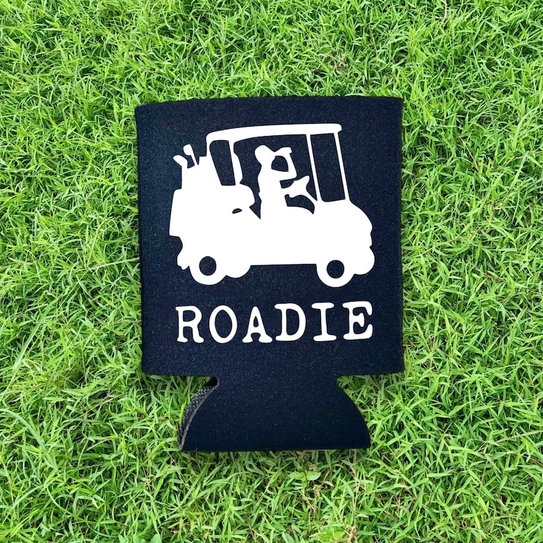 May include: Black neoprene can cooler with a white silhouette of a golf cart and the word "ROADIE" printed on it.