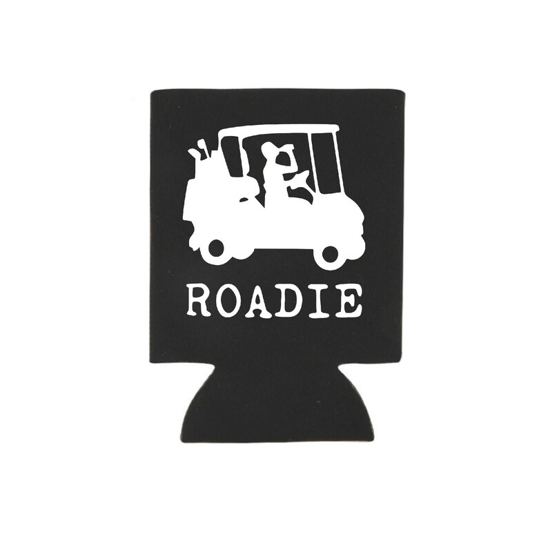 May include: Black and white golf cart design on a black neoprene can cooler with the word "ROADIE" printed below the image.