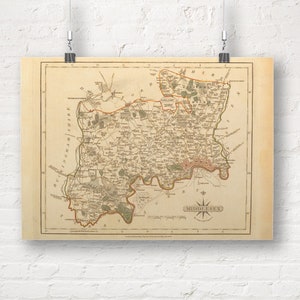 May include: An antique map of Middlesex, England, printed on aged paper with a compass rose in the lower right corner. The map shows the county's boundaries, rivers, and towns, including London.
