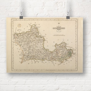 May include: An antique map of Berkshire, England, printed in black and white with brown and green accents. The map shows the county's boundaries, towns, and rivers. The title "Berkshire" is printed in a decorative font at the top of the map.
