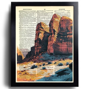 Puede incluir: Una p&aacute;gina de diccionario vintage con una imagen pintada de un paisaje des&eacute;rtico. La imagen presenta grandes formaciones rocosas rojas, un primer plano arenoso y peque&ntilde;os arbustos verdes. El texto de la p&aacute;gina est&aacute; en blanco y negro.