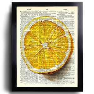 May include: A framed print featuring a vibrant, yellow lemon slice illustration. The artwork is set against a backdrop of vintage dictionary pages, with the word "BLAZE" visible at the top. The frame is black.
