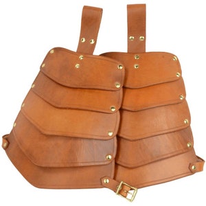 May include: A brown leather chest armor with layered plates, secured by straps and a buckle. The armor features brass rivets and is designed for protection. This medieval-style armor is suitable for cosplay or historical reenactments.