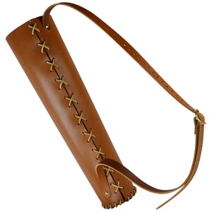 May include: A brown leather arrow quiver with a stitched design and a brown leather strap.
