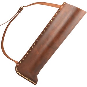 May include: A brown leather quiver with a strap for carrying arrows. The quiver is decorated with gold-colored rivets.