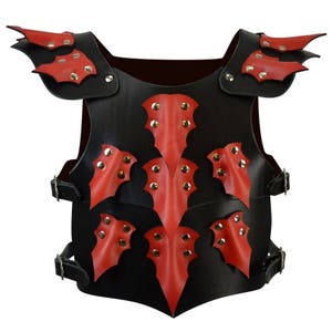 May include: Black leather armor with red leather bat-shaped accents and silver studs. The armor has straps on the sides.
