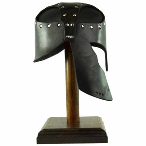 May include: Black leather helmet with a decorative design of metal studs. The helmet is on a wooden display stand.