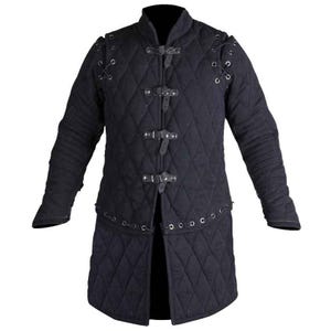 May include: A black quilted gambeson jacket featuring a diamond-stitched pattern, long sleeves, and a front closure secured by four adjustable leather straps with metal buckles. The garment includes lace-up details at the shoulders.