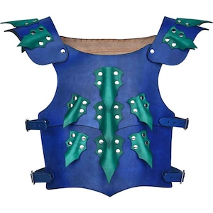 May include: Blue leather armor with green leather scales and metal accents. The armor has straps and buckles.